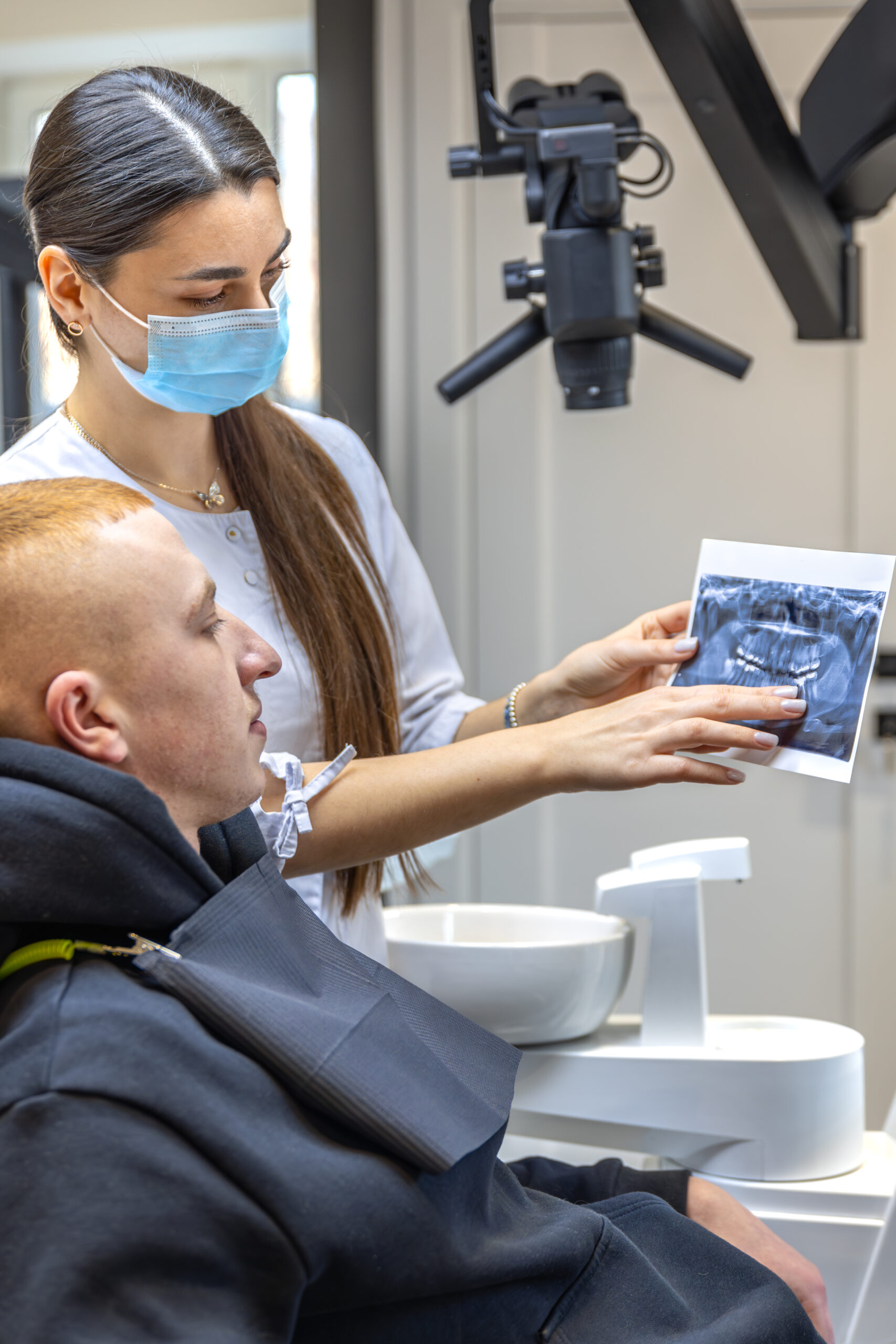young-female-dentist-showing-a-patient-a-dental-x-2026-03-24-14-06-22-utc